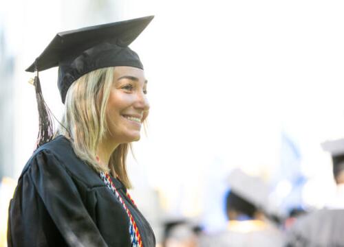 A smiling Trinity College graduate