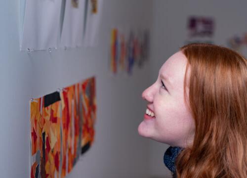 Trinity college student admiring artwork on campus